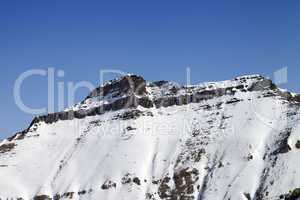 Snowy rocks with traces of avalanches