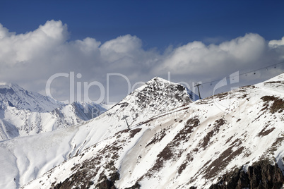 Off-piste slope and chair-lift in little snow year