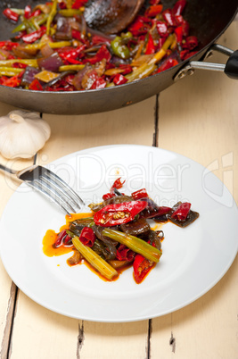 fried chili pepper and vegetable on a wok pan