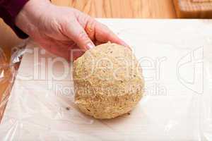 Ready shaped dough ball on plastic wrap