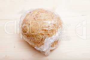 Ready shaped dough ball wrapped in plastic wrap