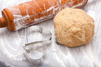 Rolling pin, cookie cutter and a dough ball