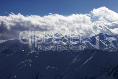 Evening sunlight mountain with clouds and silhouette of paraglid