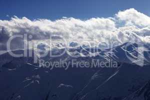 Evening sunlight mountain with clouds and silhouette of paraglid