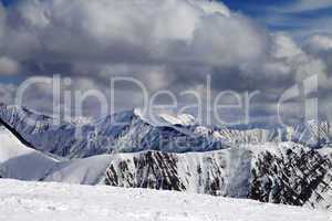 Winter snowy mountains in clouds