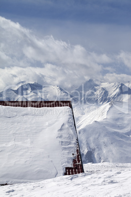 Roof of hotel in snow and ski slope