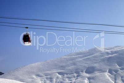 Gondola lift and off-piste slope at sun morning