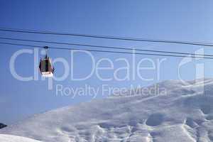 Gondola lift and off-piste slope at sun morning