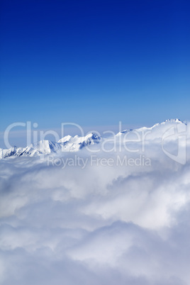 Mountains in clouds at nice sun day