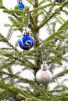 Blue and Silver Christmas Balls Hanging on a Christmas Tree