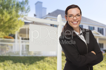 Woman In Front of House and Blank Real Estate Sign