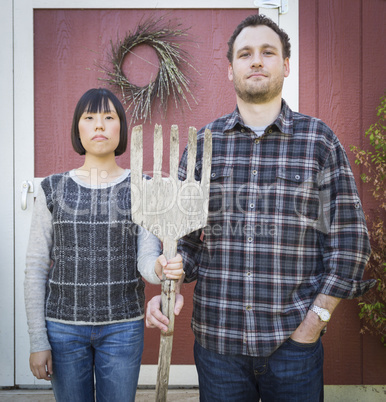 Fun Mixed Race Couple Portrait Simulating the American Gothic Pa