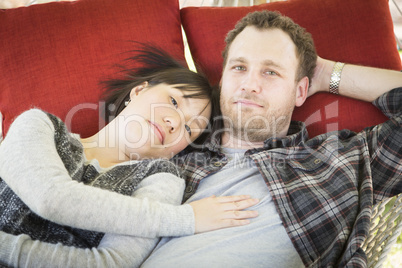 Mixed Race Couple Relaxing in a Hammock