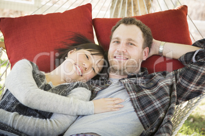 Mixed Race Couple Relaxing in a Hammock