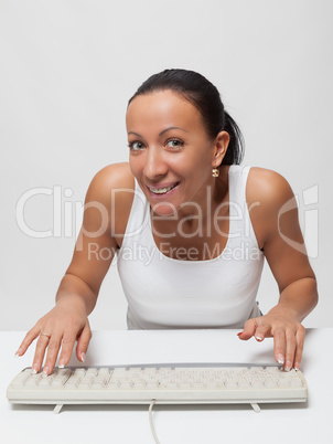 Woman with keyboard looking up. Working at home.
