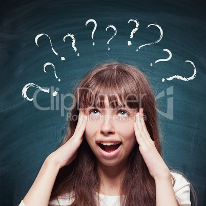 Young girl with questioning expression and question marks above