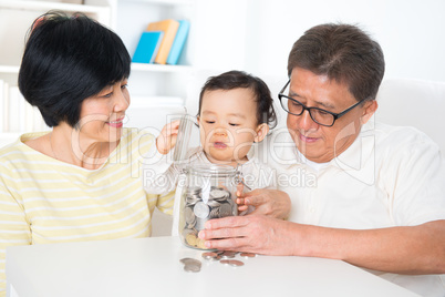 Asian family saving coins
