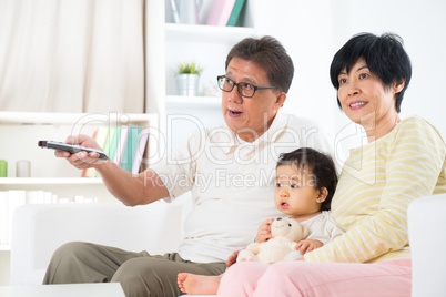 Asian family watching tv