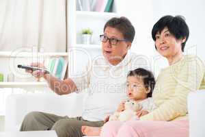 Asian family watching tv