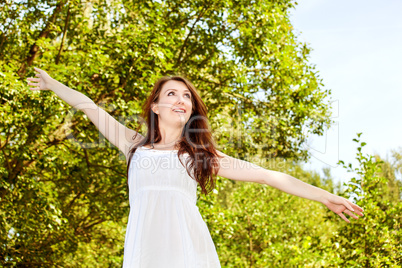 Woman with zest for life has arms outstretched