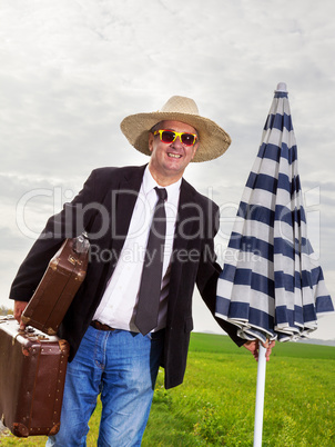 Man with suitcase and umbrella