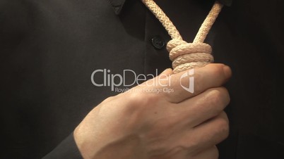man pulls a rope noose