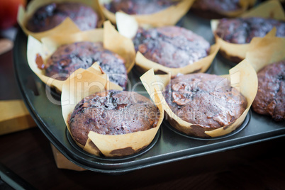 Chocolate muffins with blueberry on cooking pan