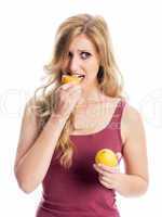 Frau beisst in eine Zitrone