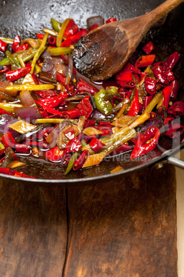 fried chili pepper and vegetable on a wok pan