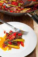 fried chili pepper and vegetable on a wok pan