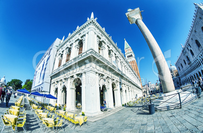 VENICE - APRIL 7, 2014: Tourists enjoy Saint Mark Square on a be