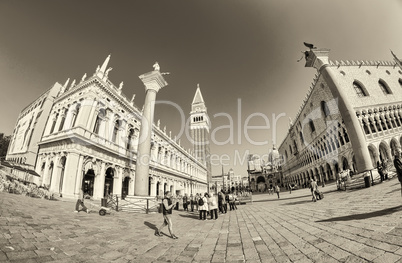 VENICE - APRIL 7, 2014: Tourists enjoy Saint Mark Square on a be