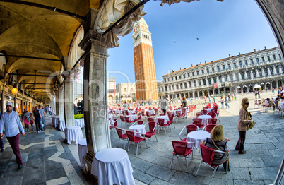 VENICE - APRIL 7, 2014: Tourists enjoy Saint Mark Square on a be