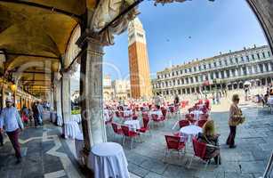 VENICE - APRIL 7, 2014: Tourists enjoy Saint Mark Square on a be