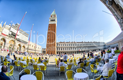 VENICE - APRIL 7, 2014: Tourists enjoy Saint Mark Square on a be