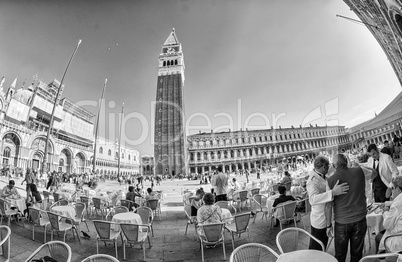 VENICE - APRIL 7, 2014: Tourists enjoy Saint Mark Square on a be