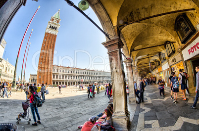 VENICE - APRIL 7, 2014: Tourists enjoy Saint Mark Square on a be