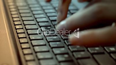 Women's hands typing on computer keyboard