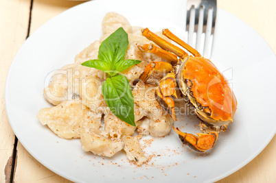 Italian gnocchi with seafood sauce with crab and basil