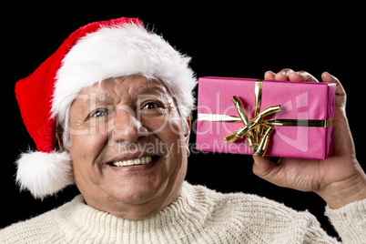 Excited Old Man With Santa Cap And Magenta Gift