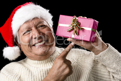 Aged, But Vivid Gentleman Pointing At Wrapped Gift