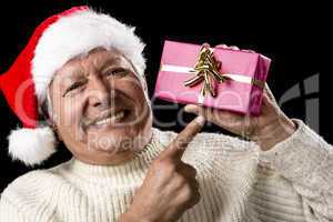 Aged, But Vivid Gentleman Pointing At Wrapped Gift