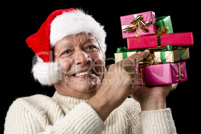 Male Senior Firmly Pointing At Six Wrapped Gifts