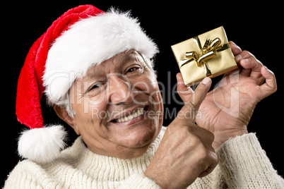 Playful Male Pensioner Pointing At Golden Gift