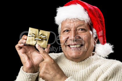 Joyful Old Man Gesturing At Wrapped Golden Gift