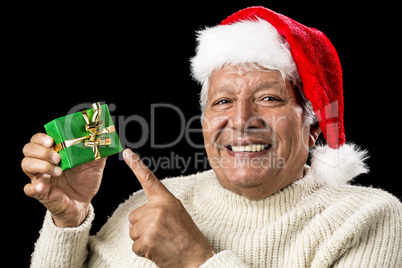 Cheerful Old Man Pointing At Green Wrapped Gift