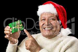 Cheerful Old Man Pointing At Green Wrapped Gift