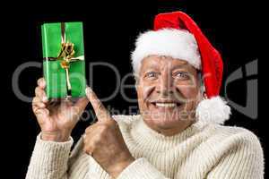 Gleeful Aged Man Pointing At Raised Green Present