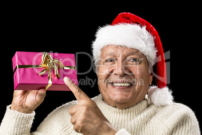 Joyous Old Man Pointing At Magenta Wrapped Gift