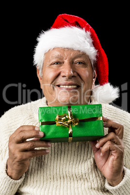 Smiling Old Man Handing Over A Wrapped Green Gift